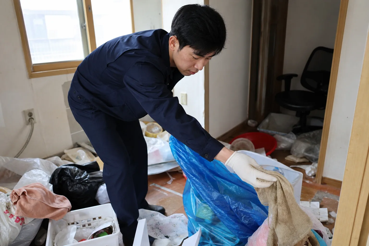 의정부시 녹양동 쓰레기집 청소 현장에서 전문 직원이 폐기물을 정리하고 있는 모습